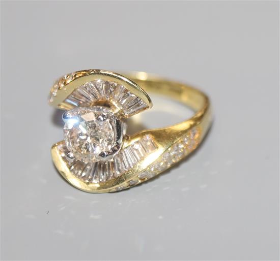 A modern 18k gold and single stone diamond ring and baguette cut diamond setting, size K.